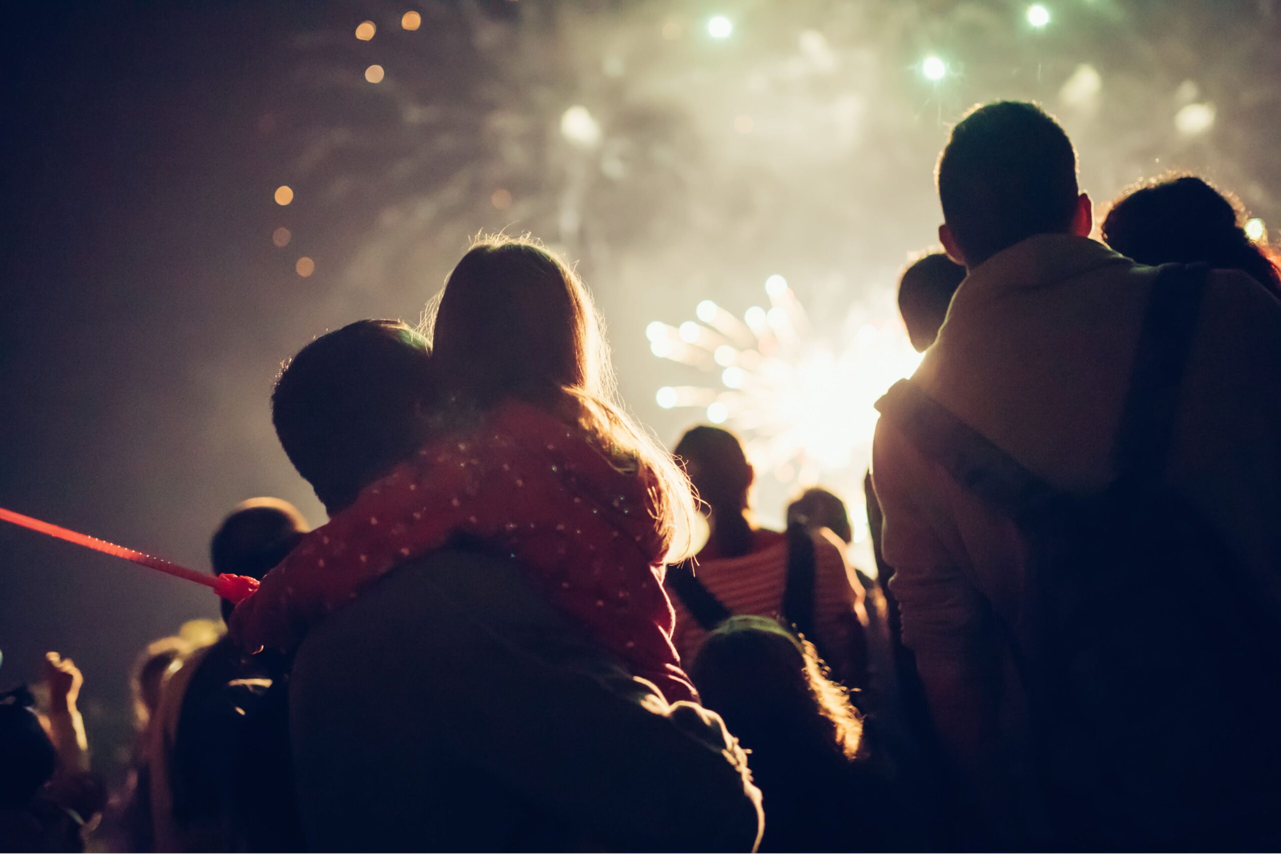 British families enjoying Bonfire Night fireworks display with children watching sparklers and bonfires during traditional Guy Fawkes celebration in UK