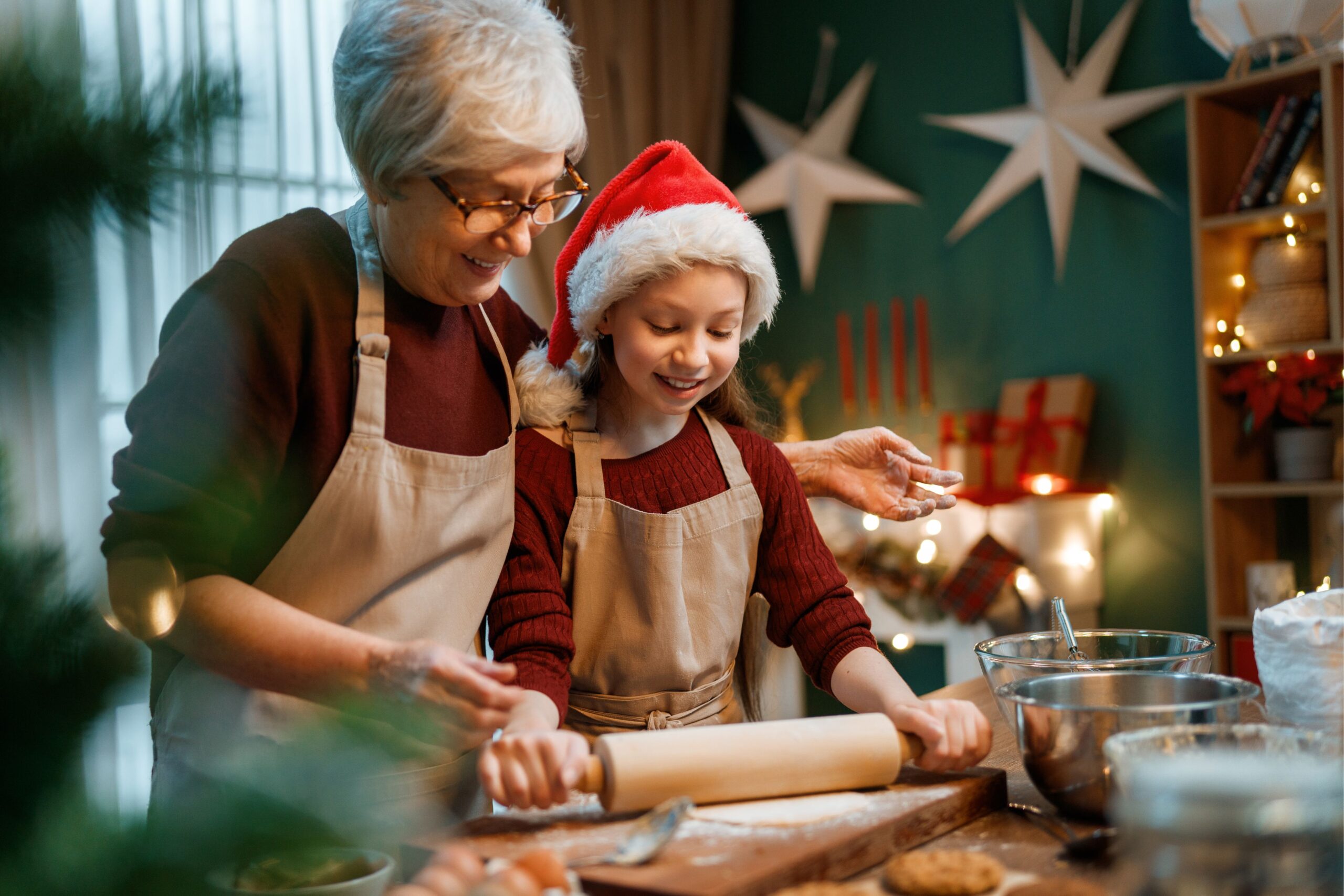 Making Gluten-Free Cookies for Christmas by grandmother and young girl with christmas hat