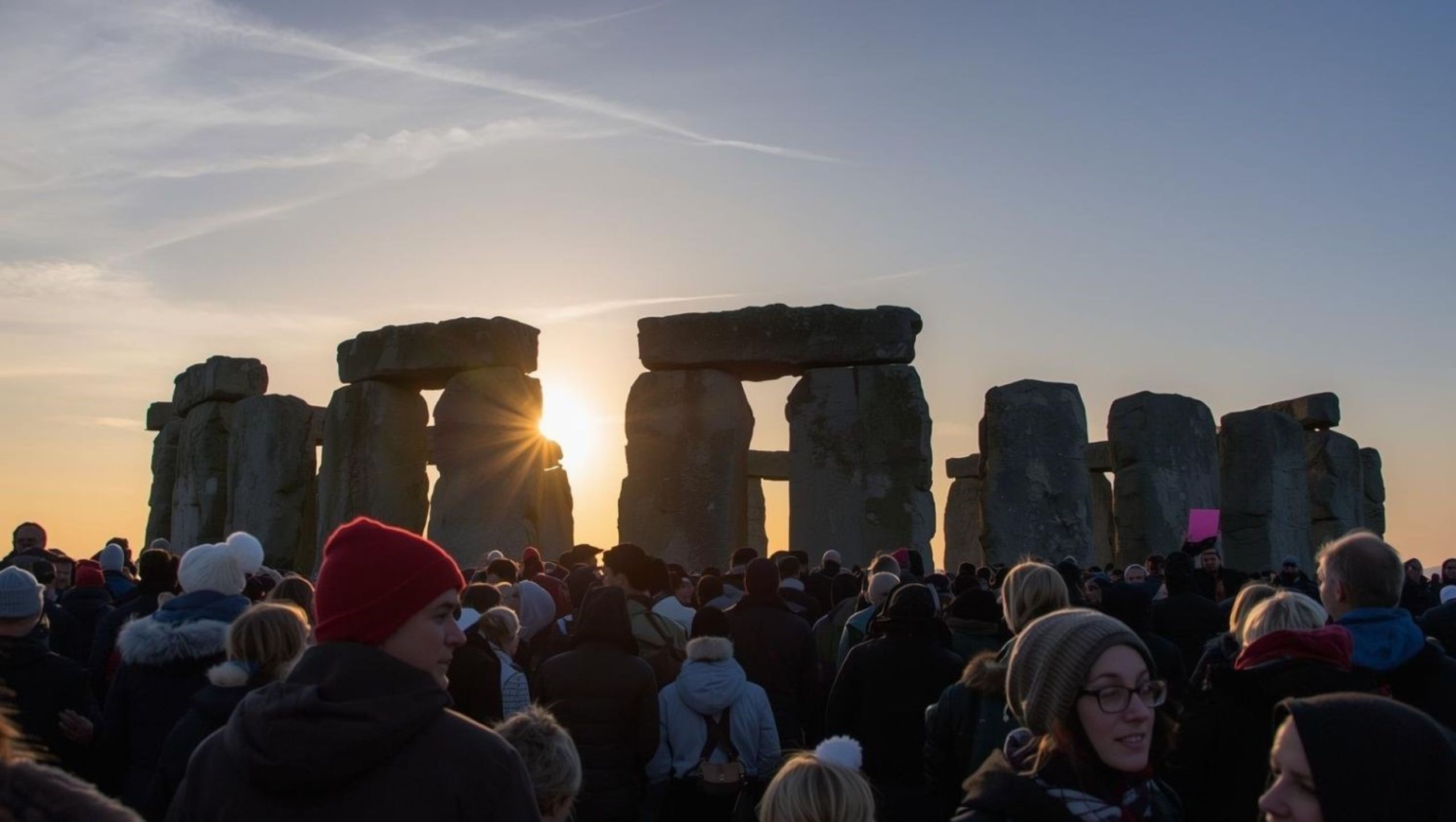 Thousands gathering at Stonehenge for winter solstice sunrise celebrations on December 21, representing ancient European feast traditions honoring shortest day and longest night of year