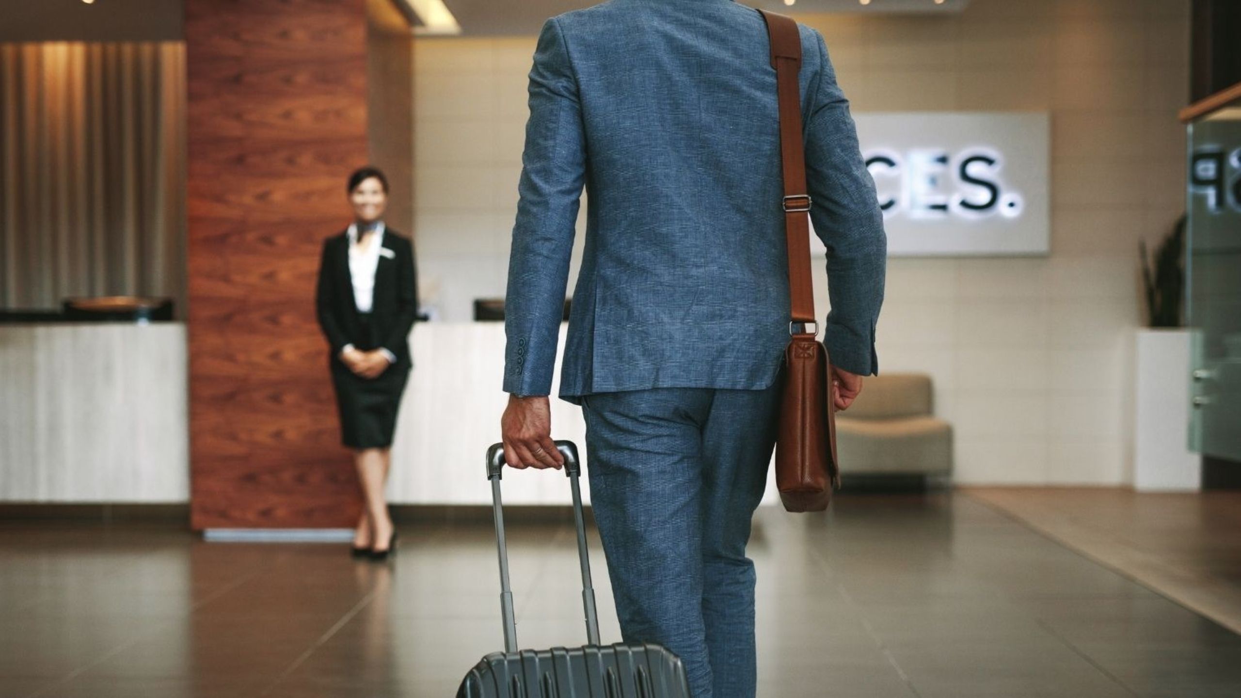 European business travel with professional travelers at airport representing corporate hotel trends