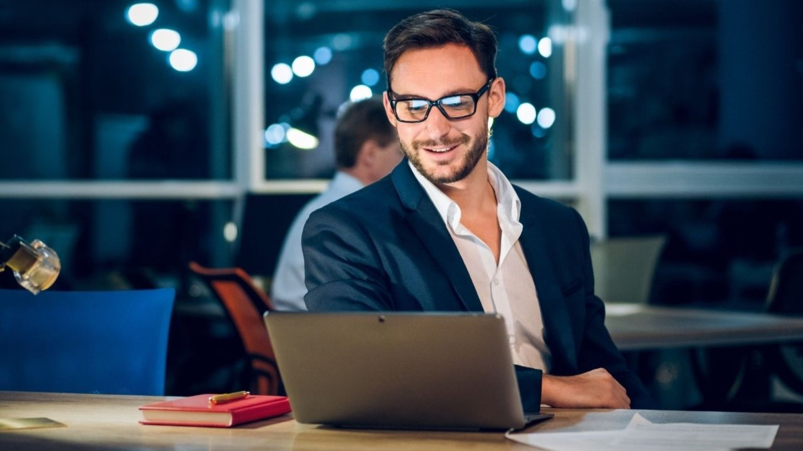 Bootstrap startup founder working on laptop in European cafe building profitable business