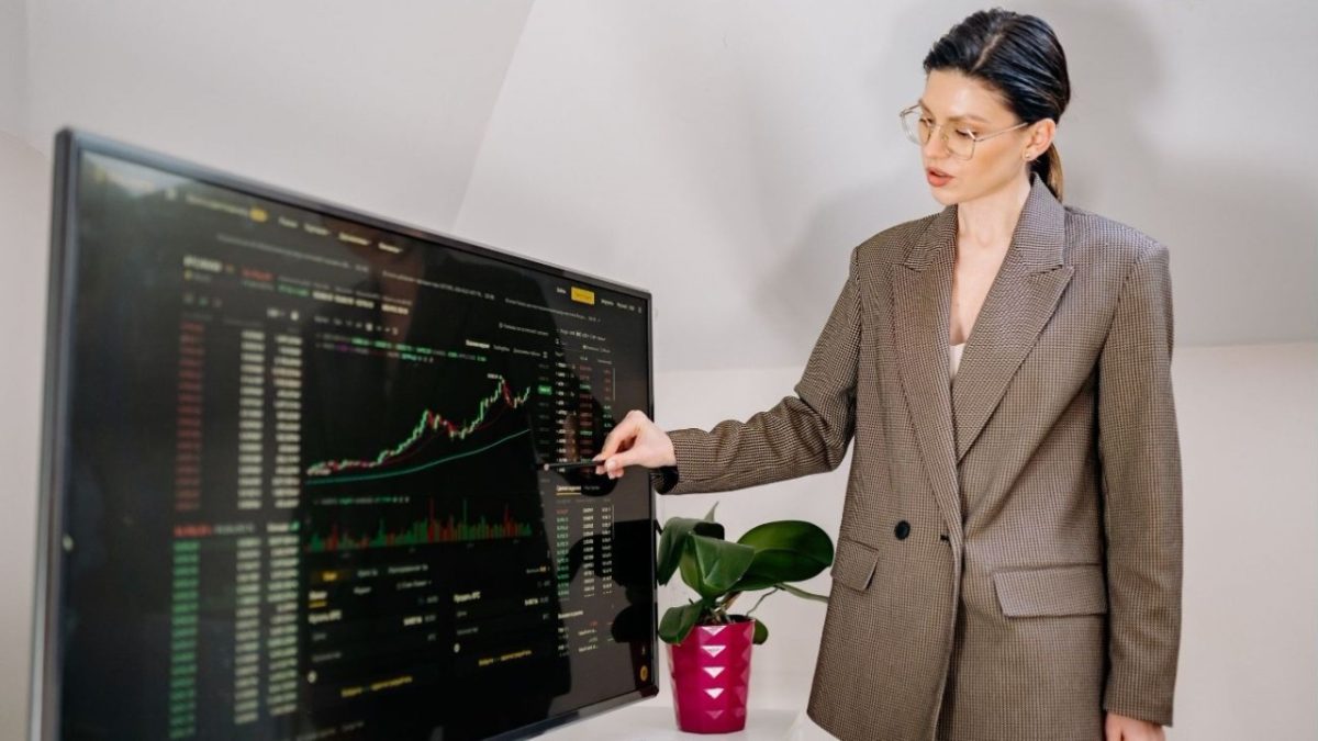 A businesswoman reviews a map of EU cohesion funds allocation by region in a modern office