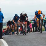 A cyclist pushes through a mountain stage crowd during one of the most iconic open-air sporting events in Europe