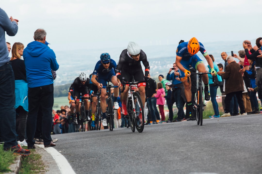 A cyclist pushes through a mountain stage crowd during one of the most iconic open-air sporting events in Europe