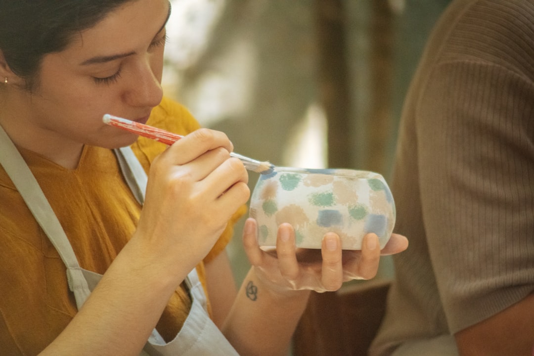 A woman artisan hand-painting porcelain in one of Europe's most celebrated EU-protected craft regions