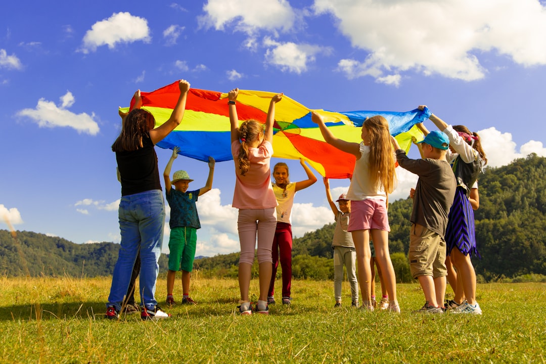 A group of children attending EU summer camps, sitting outdoors and practicing language activities together