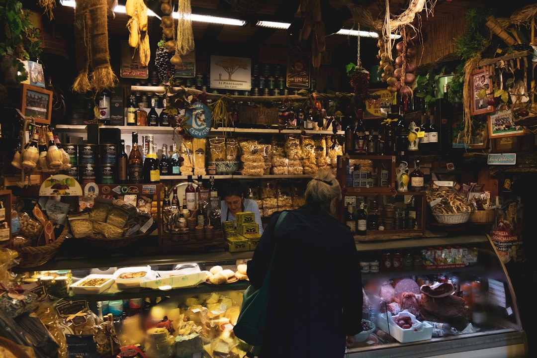 A woman tasting Parmigiano Reggiano in a traditional Italian caseificio, a celebrated EU geographical indication food.