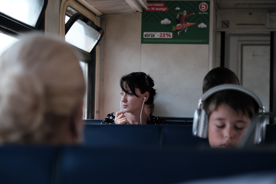 A woman reading in a private cabin aboard overnight trains across Europe, soft evening light through the window