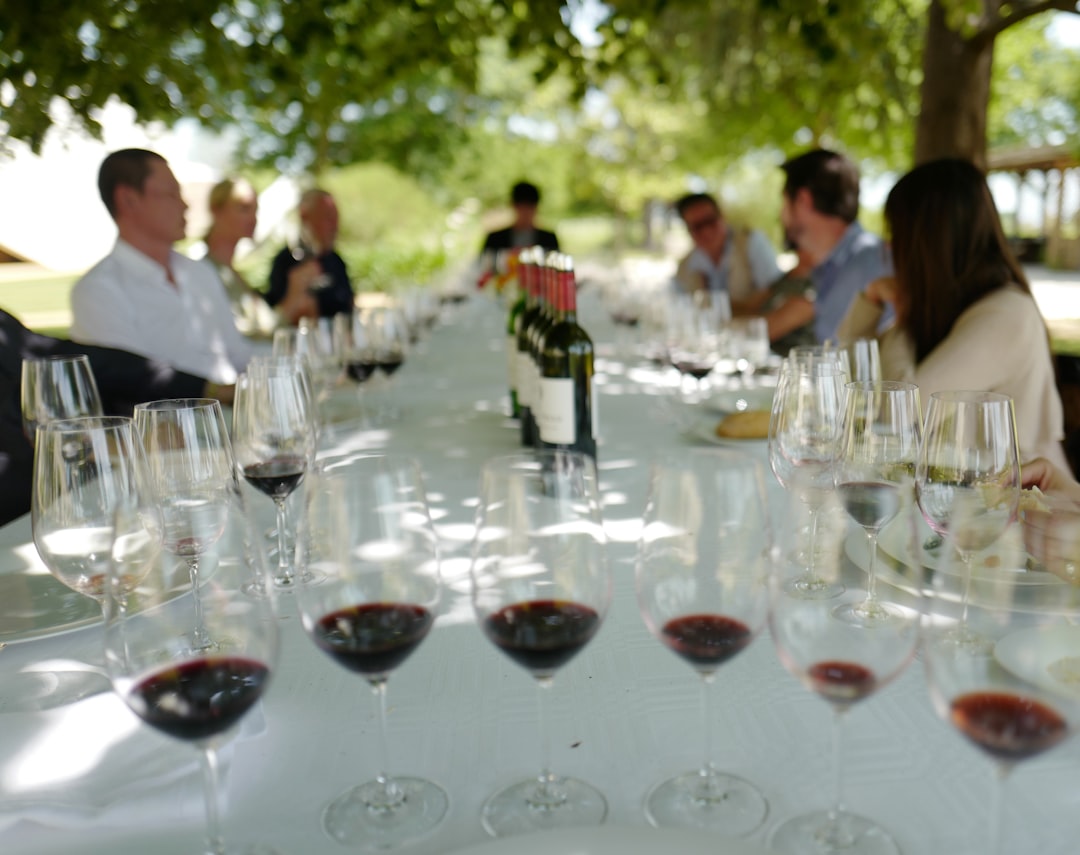 A sommelier guides a guest through a private tasting inside a historic EU vineyard cellar in Burgundy, France