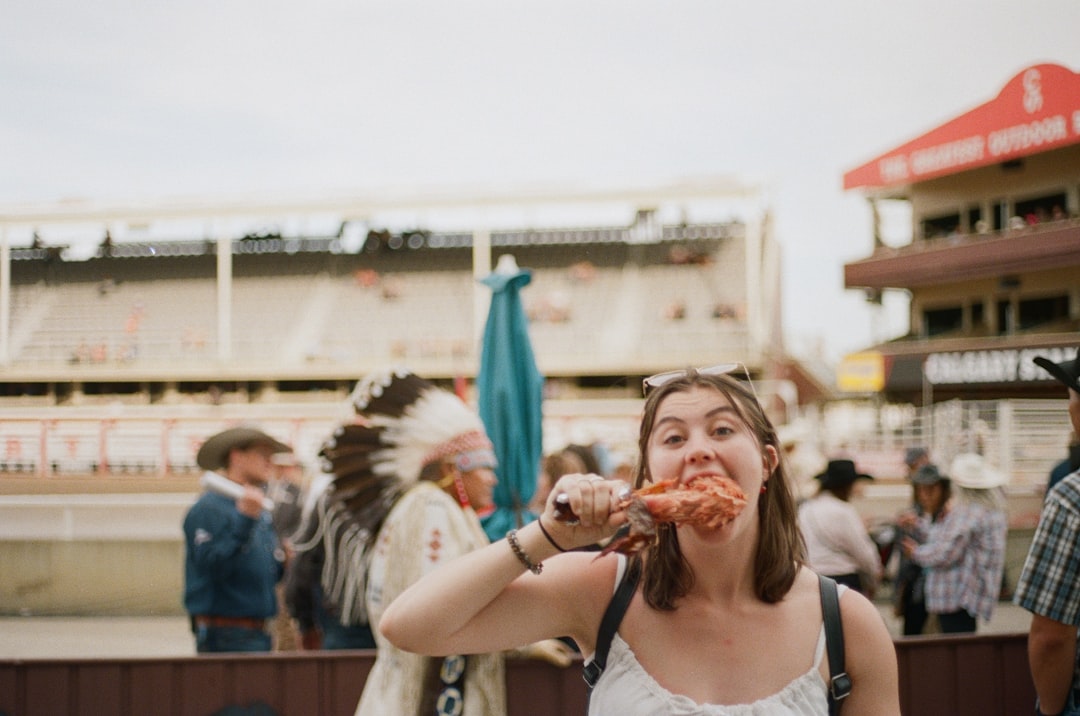A woman carefully reading allergen free product labels at a vibrant European summer festival market stall