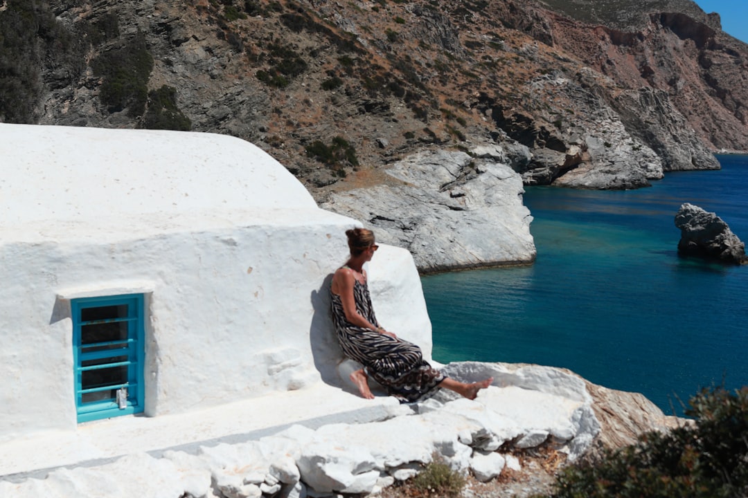 A woman arriving by boat at a private island in the Greek Aegean, embodying the seclusion of EU private island rentals