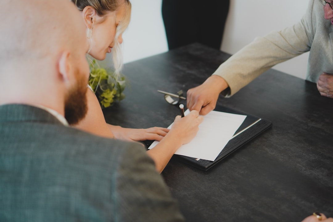 A startup founder signing EU trademark registration documents as part of an IP protection strategy