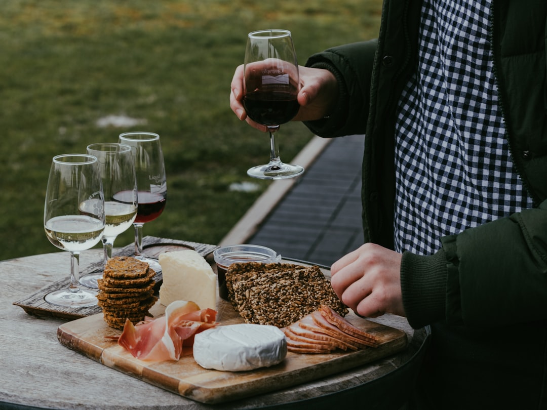 A sommelier carefully pours EU wines beside a regional cheese board at an elegant European table