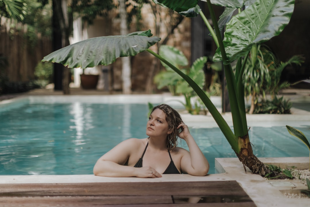 A woman rests in a private mineral pool at one of Europe's most exclusive thermal retreats, surrounded by stone terraces.