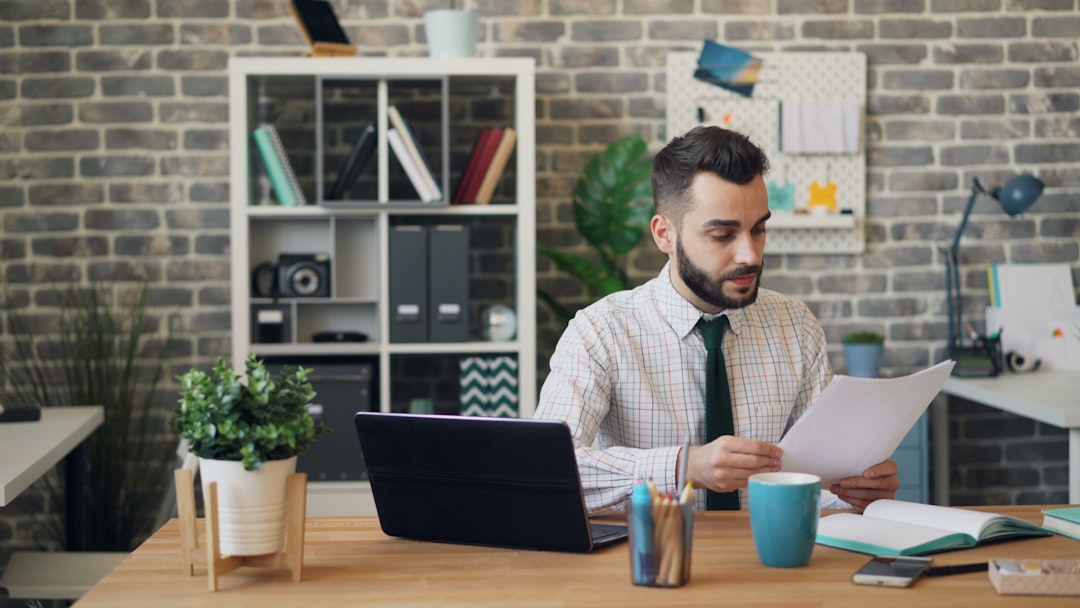 A growth-stage startup founder reviews EU state aid funding documents at her office desk