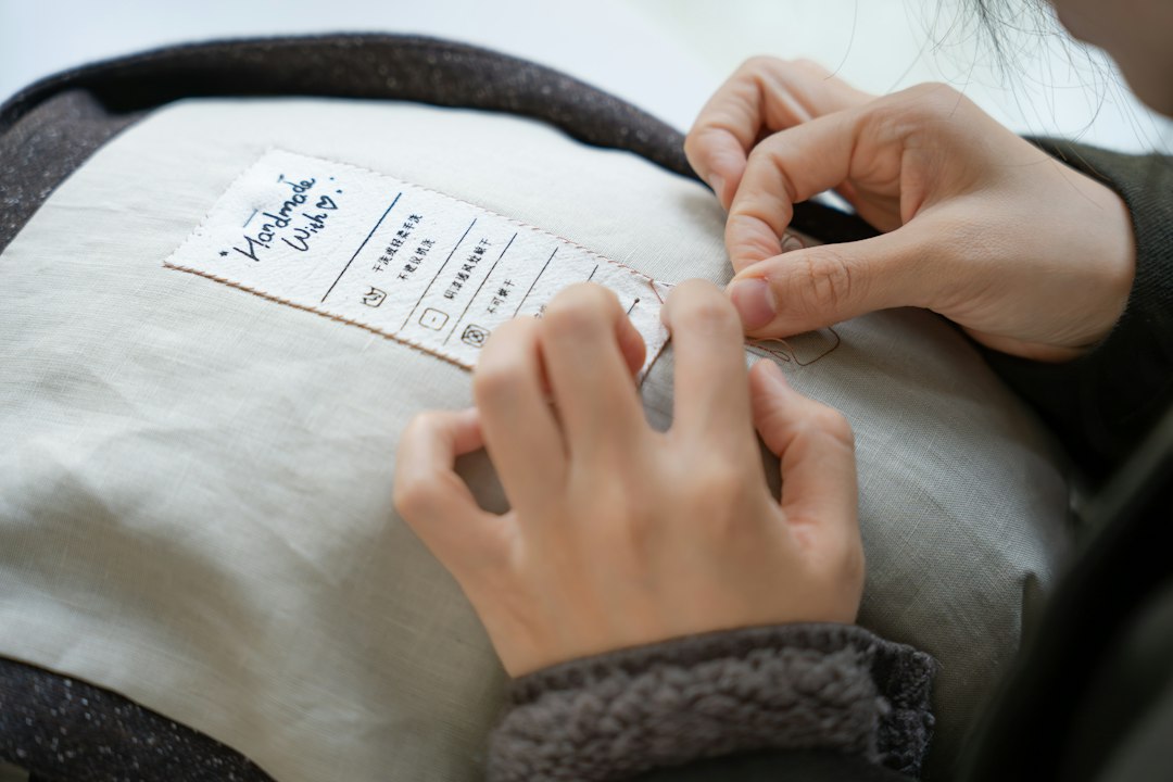 A woman examining a clothing label in a retail store to verify green claims before purchasing